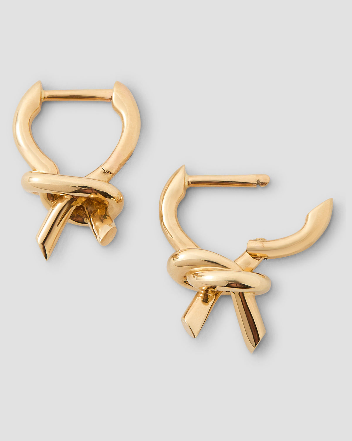 Knot Huggie earring - styled on model | gold huggie earrings