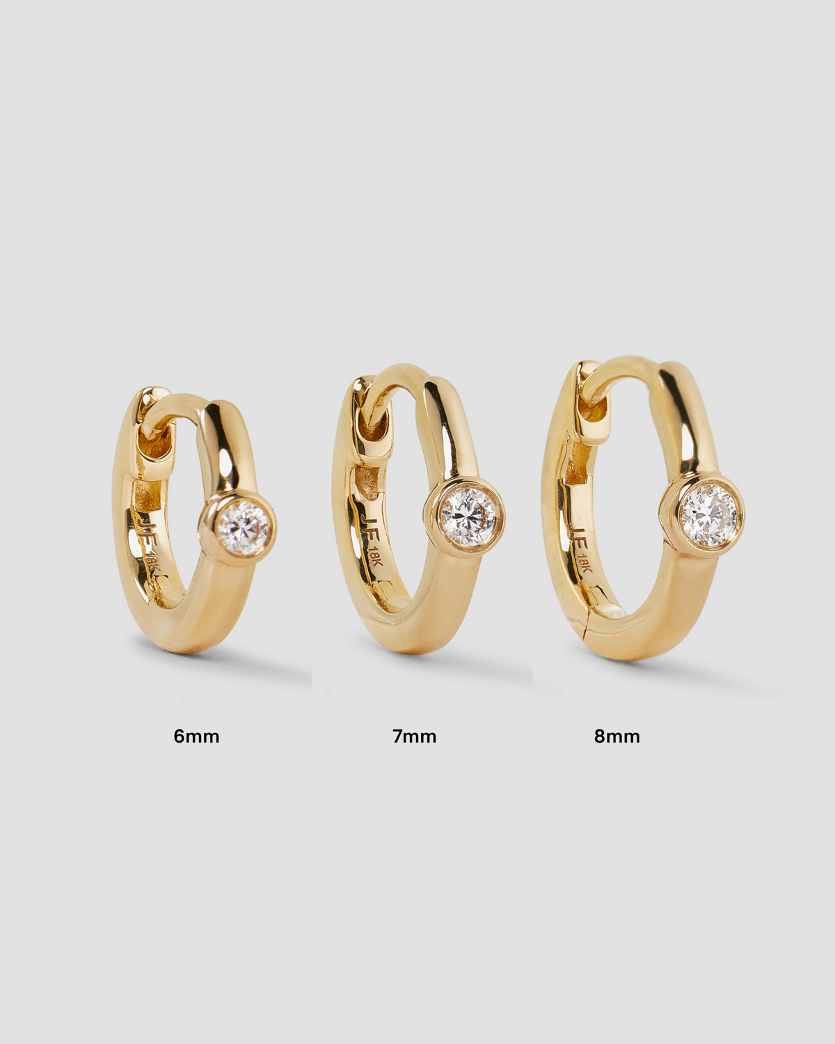 18K Essential Single Stone Tiny Huggie gold earring - styled on model | diamond huggie earrings
