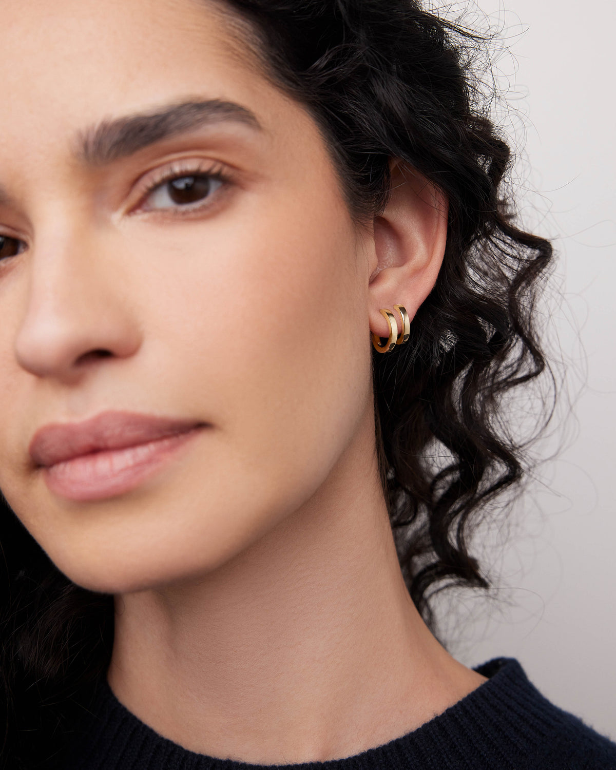 18k Small Huggie earring - alternate angle | gold huggie earrings