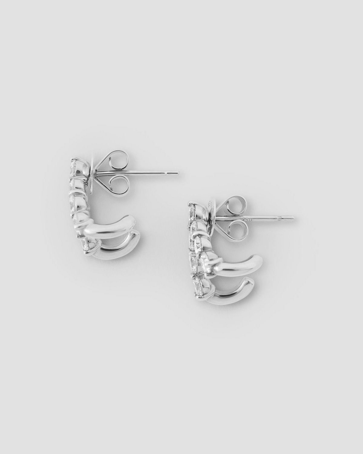 Floating Seven Diamond Double Huggies 18K gold earring - product detail shot | diamond huggie earrings