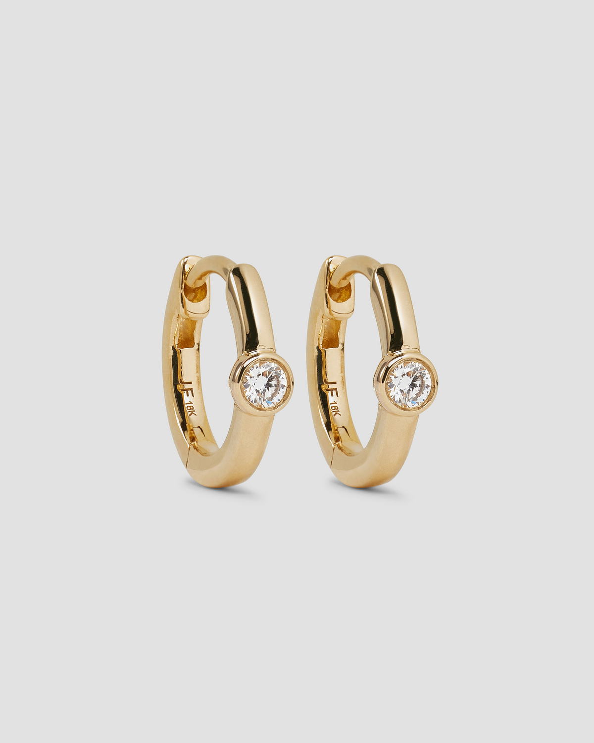 18K Essential Single Stone Tiny Huggie gold earring - styled on model | diamond huggie earrings