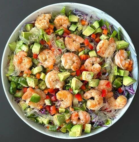 Colorful salad consisting of romaine and butter lettuce, purple cabbage, basil, carrots, red pepper, cucumber, avocado and kelp noodles. Topped with sautéed shrimp and dressed with JF Almond Butter Dressing and JF Spicy Salt. 