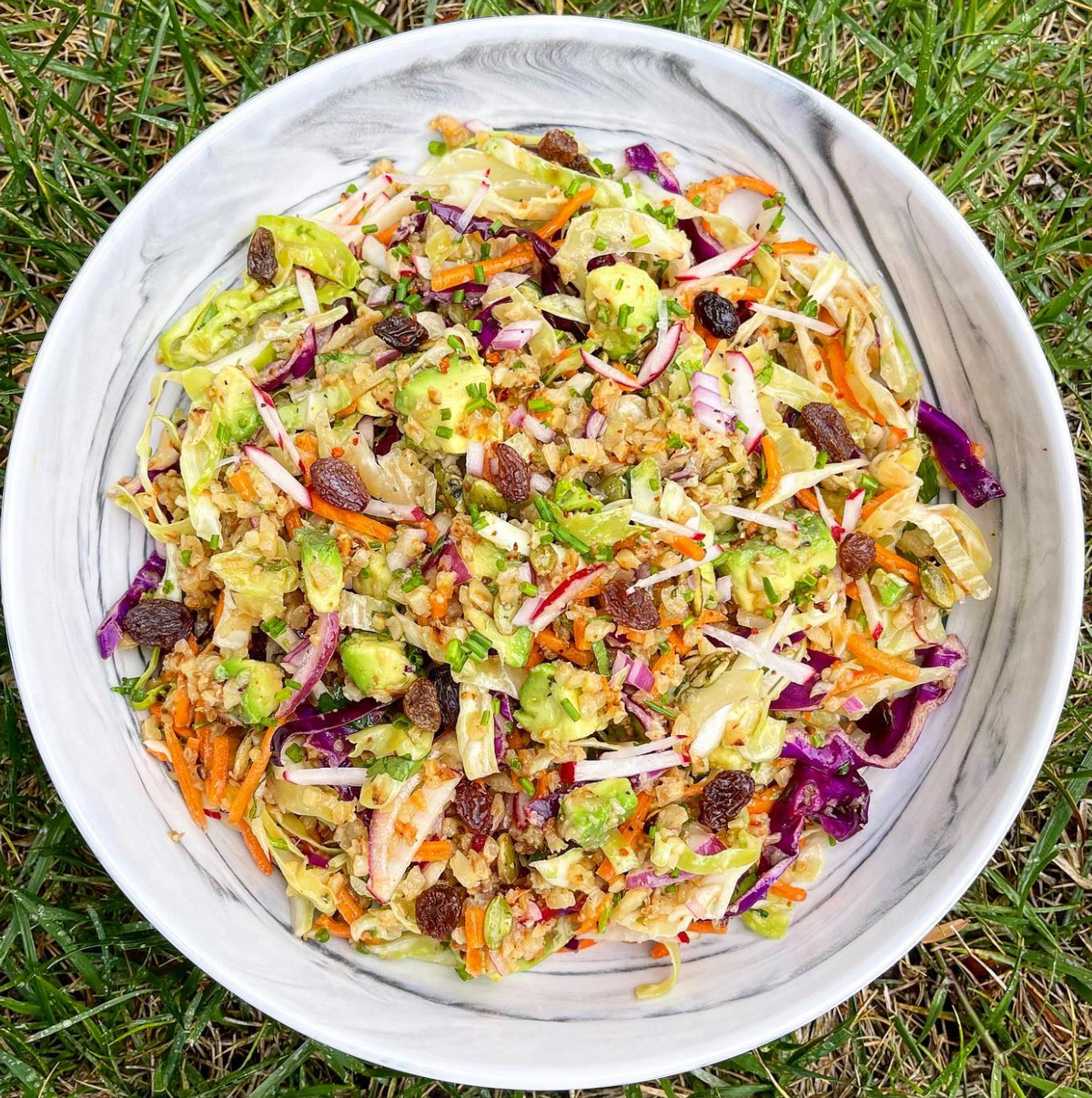 Colorful salad with cabbage, avocado, cauliflower rice in a bowl