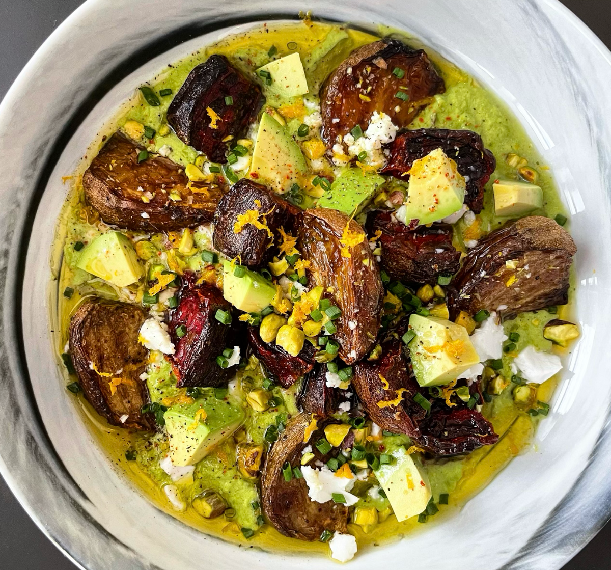photo of beetroot in a bowl with avocado in a green sauce