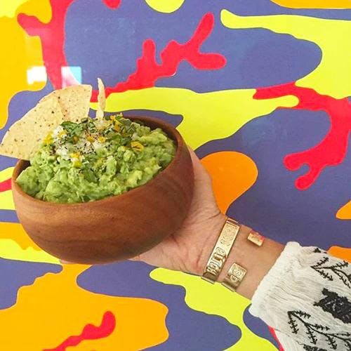 Bowl packed with fresh California Style Guacamole. Garnished with 3 tortilla chips on top. 