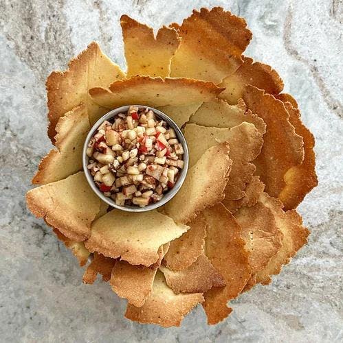 Bowl of walnut free haroset with grain-free matzo for passover. 
