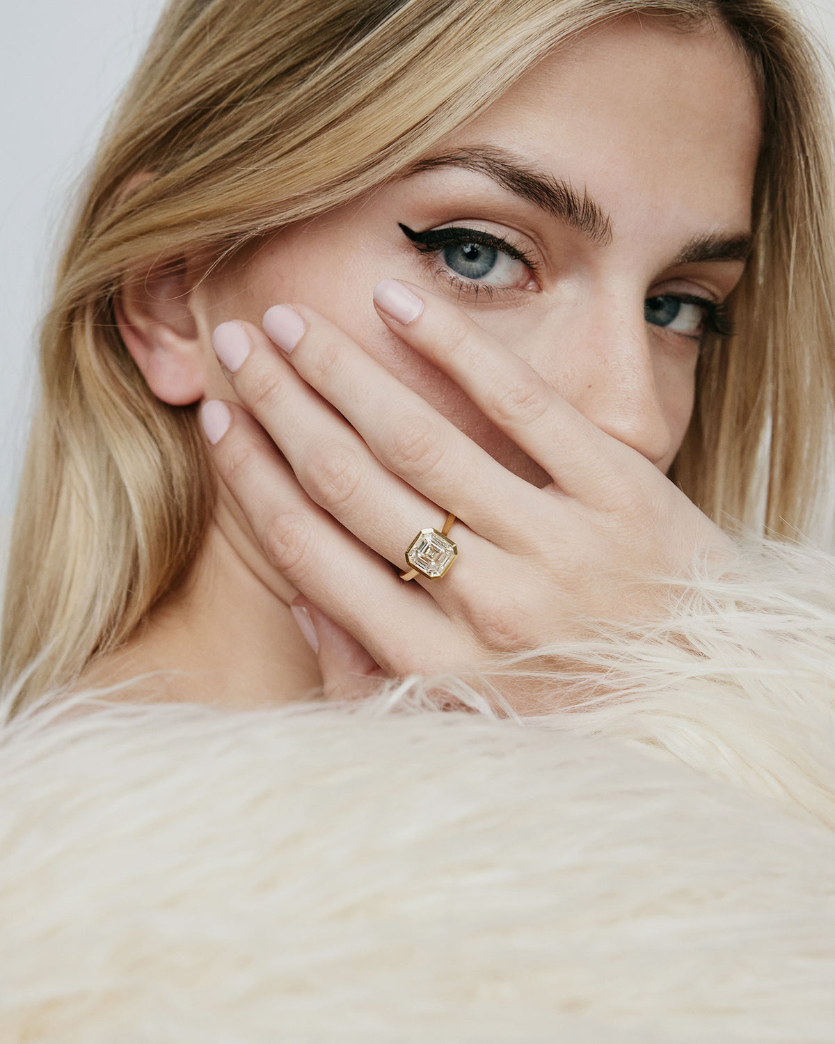 Model wearing square shaped diamond on gold band