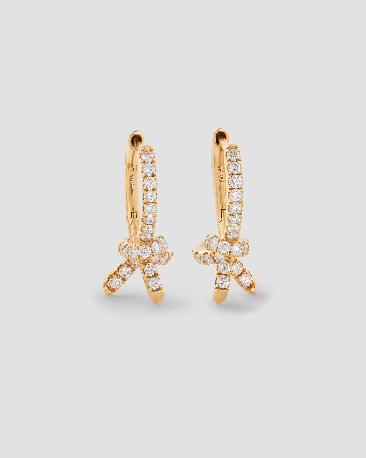 Knot Huggie with Pavé White Diamonds gold earring - front view | diamond huggie earrings