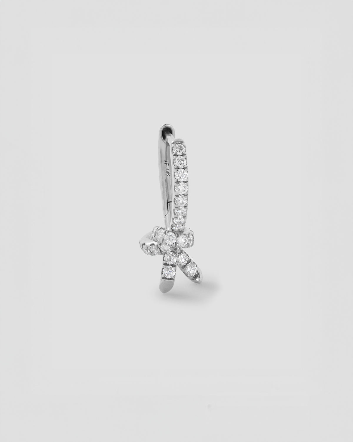 Knot Huggie with Pavé White Diamonds gold earring - worn look | diamond huggie earrings
