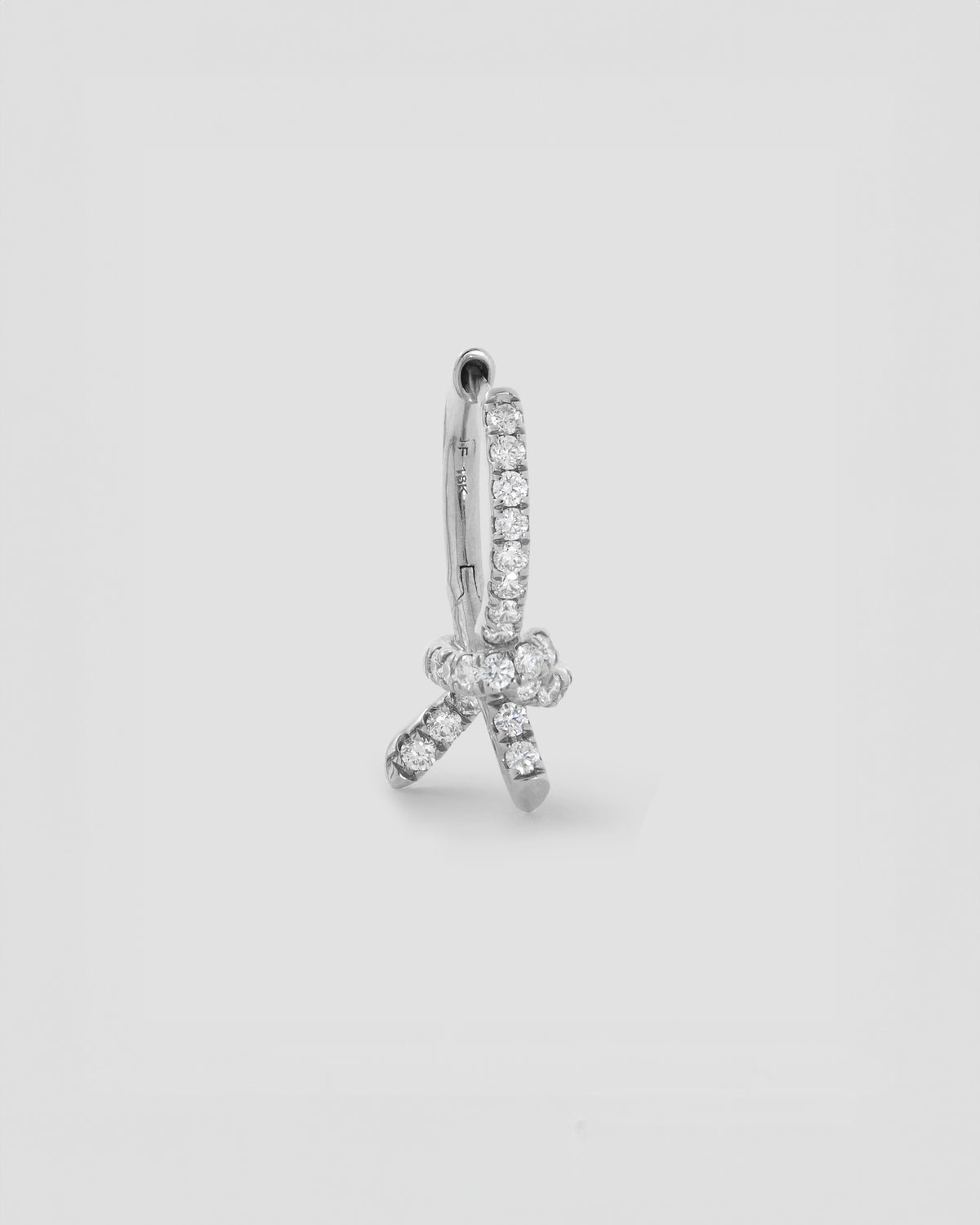 Knot Huggie with Pavé White Diamonds gold earring - product detail shot | diamond huggie earrings