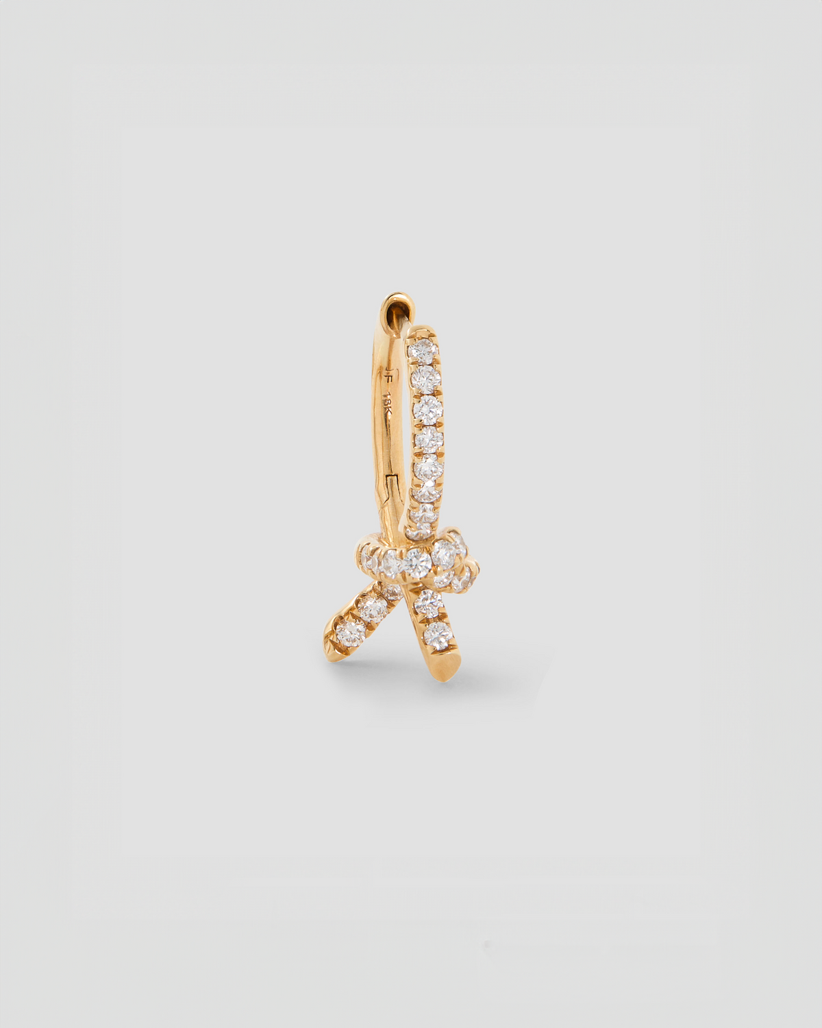 Knot Huggie with Pavé White Diamonds gold earring - side view | diamond huggie earrings