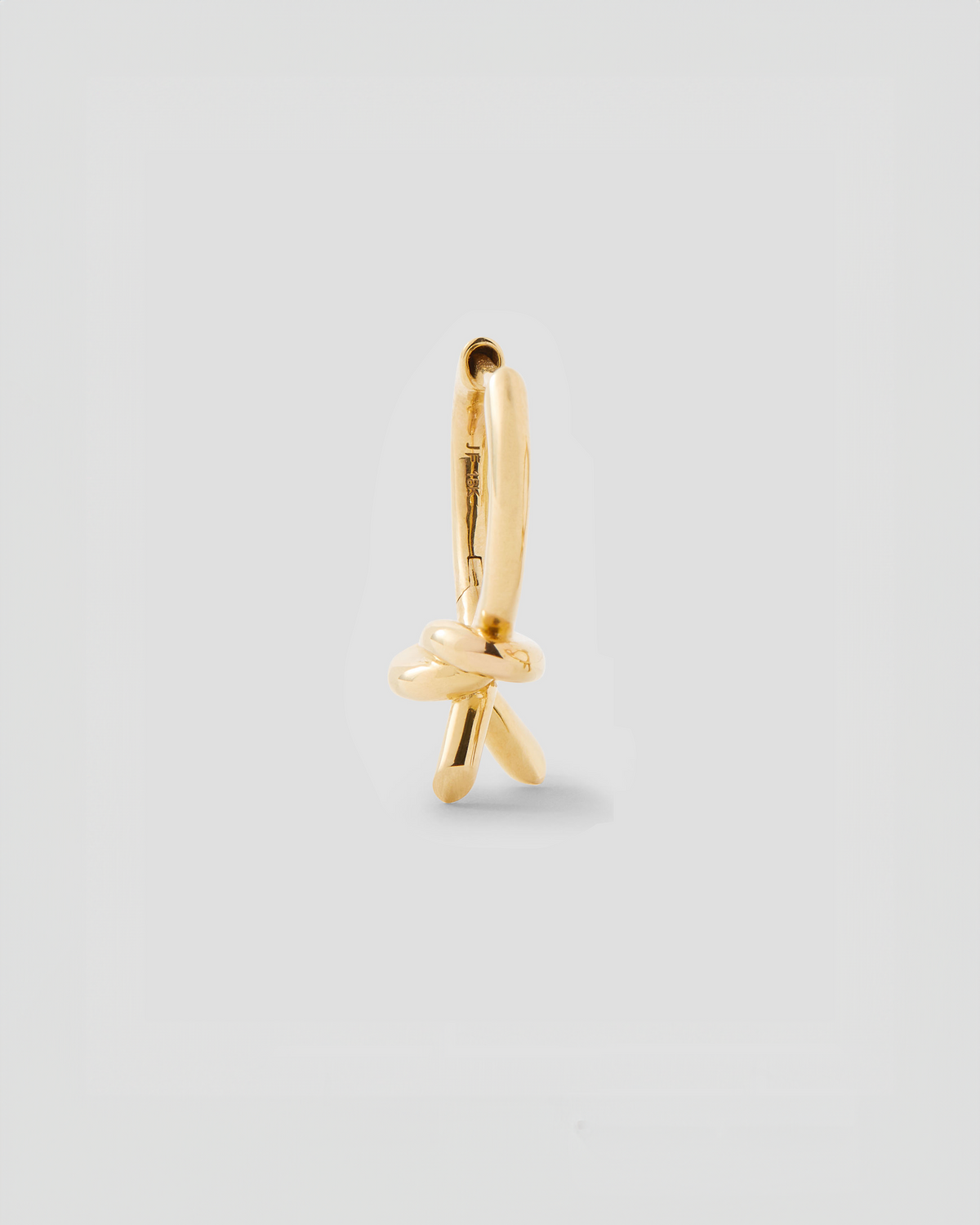 Knot Huggie earring - alternate angle | gold huggie earrings