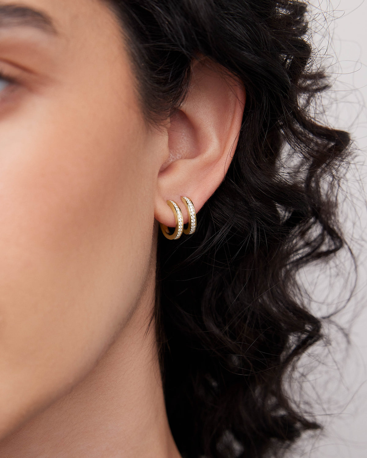 18k Small Huggie with Pavé Diamonds 18K gold earring - styled on model | diamond huggie earrings