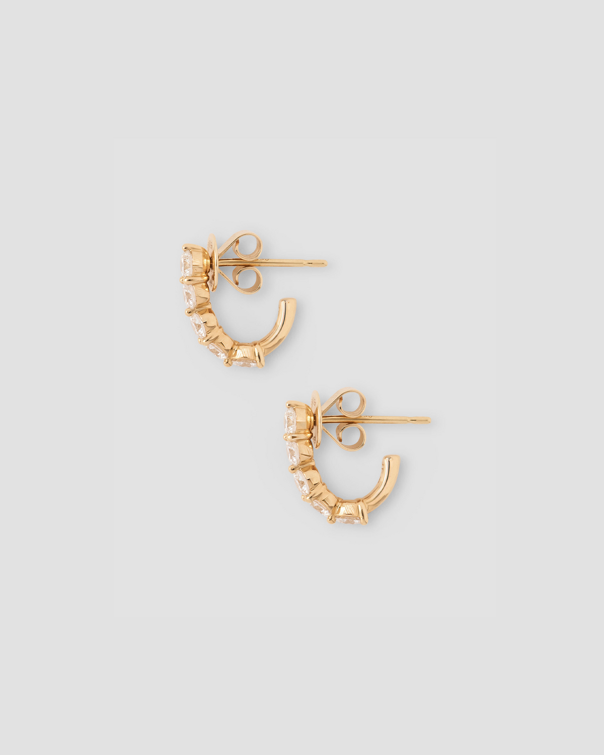 Floating Five Diamond Huggies 18K gold earring - alternate angle | diamond huggie earrings