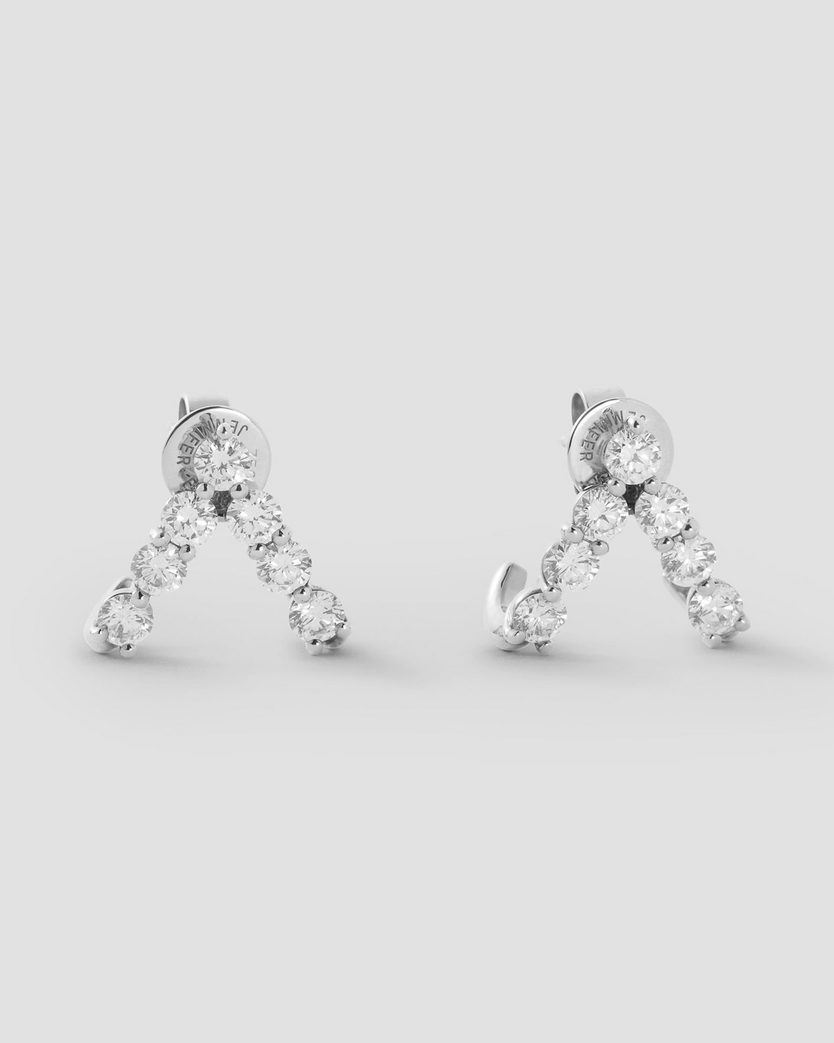 Floating Seven Diamond Double Huggies 18K gold earring - styled on model | diamond huggie earrings