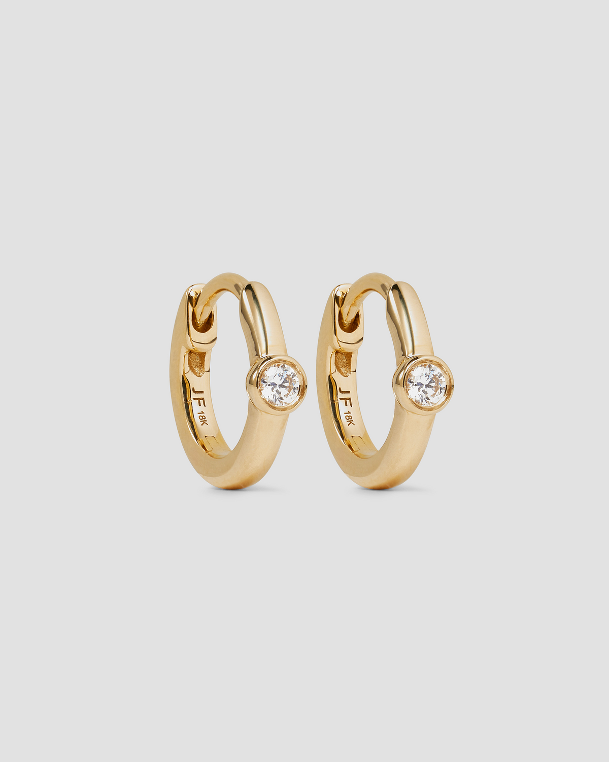 18K Essential Single Stone Tiny Huggie gold earring - product detail shot | diamond huggie earrings